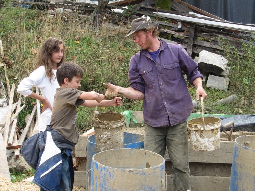 Kids helping with mud buckets